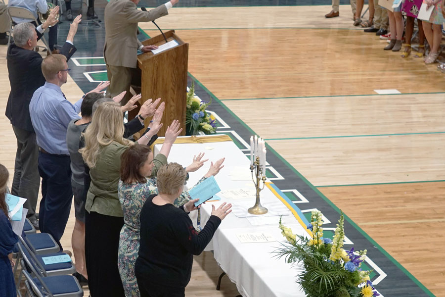 Principal Mr. Dave Worland, in top left corner, participates in last spring's National Honor induction. Worland is a constant presence at school events. 