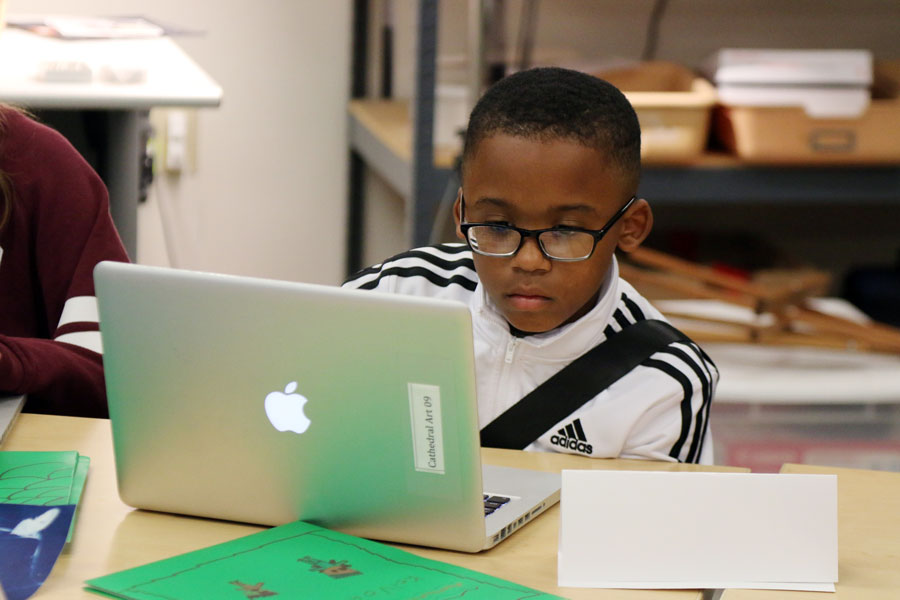 An elementary school student participates in a Camp Cathedral session in Cunningham Hall. 