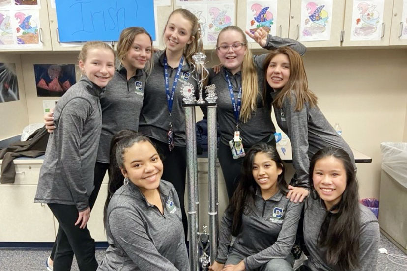 Show choir members show off their trophy from the competition at Fishers High School. 