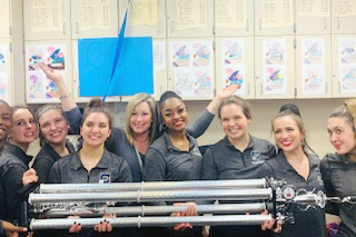 Ms. Marian Bender and members of the Irish Adrenaline show choir off their Grand Champion trophy from the Feb. 1 competition at Fishers High School. 