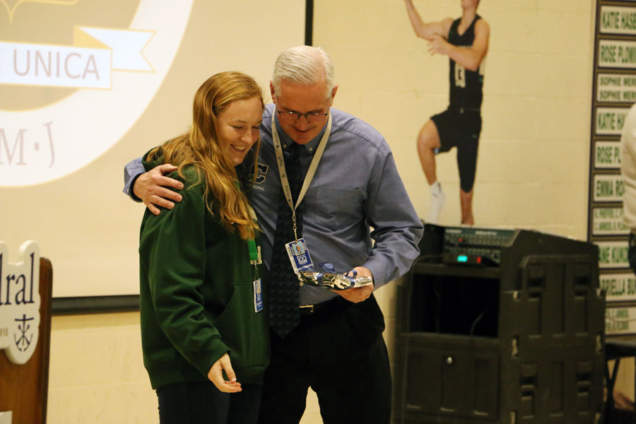 Senior Ellie Sheddy presents Mr. Mark Matthews with his Spirit of Holy Cross award at the Jan. 31 Winterfest assembly. 