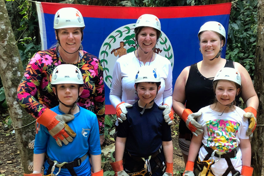 Mrs. Karen Hovanec, top left, and her fellow 2019 spring break travelers in Roatan, Honduras about to go zip lining. 