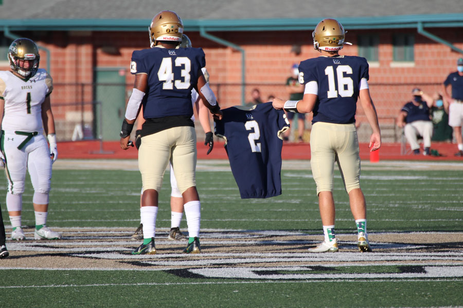 Mario McCullough's jersey is carried onto the field before the varsity football team's season opener at Westfield. 