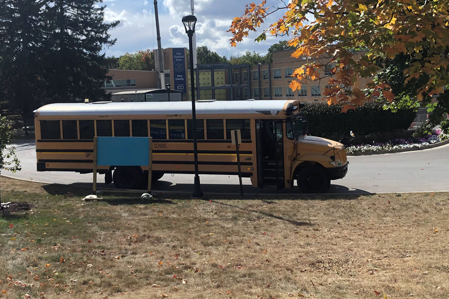 A driver waits on the circle to pick up his students for his afternoon route. Drivers are doing extra cleaning on the vehicles to ensure the safety of their riders.