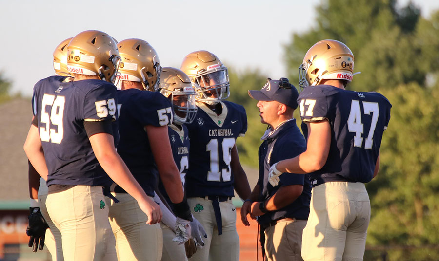 Senior David Guhl and his teammates hear from Assistant Coach Mr. Adam Barth. 