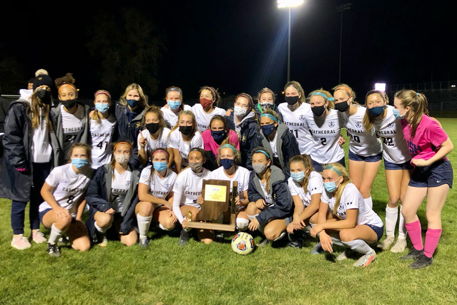 The State-bound women's soccer team shows off its Regional champion trophy. 