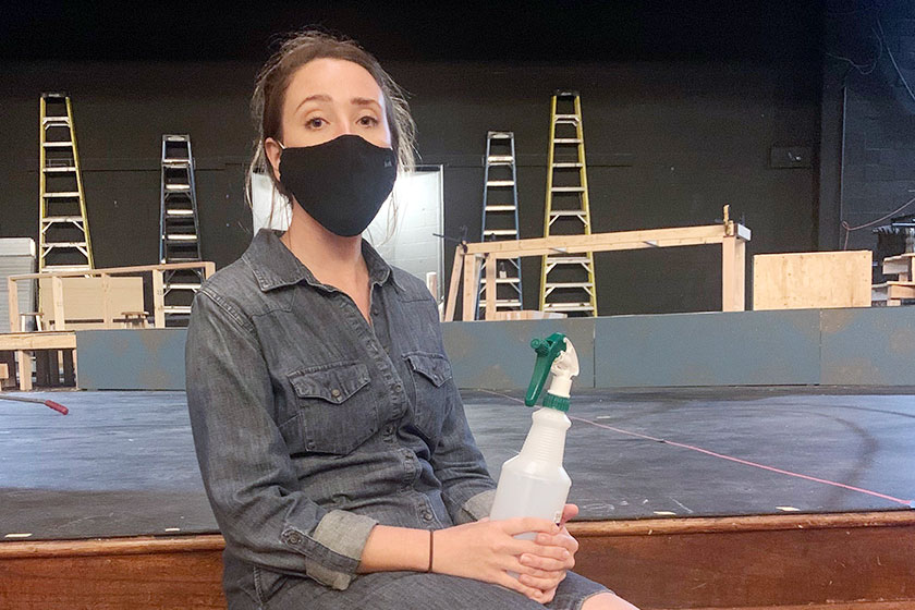 Disinfectant spray bottle in hand, theater director Ms. Maria Souza sits in the auditorium during before E period before her tech theater class. 