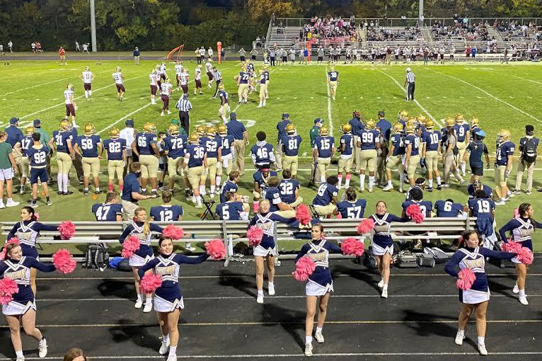 The varsity football team prepares to take the field earlier this season against Center Grove. 