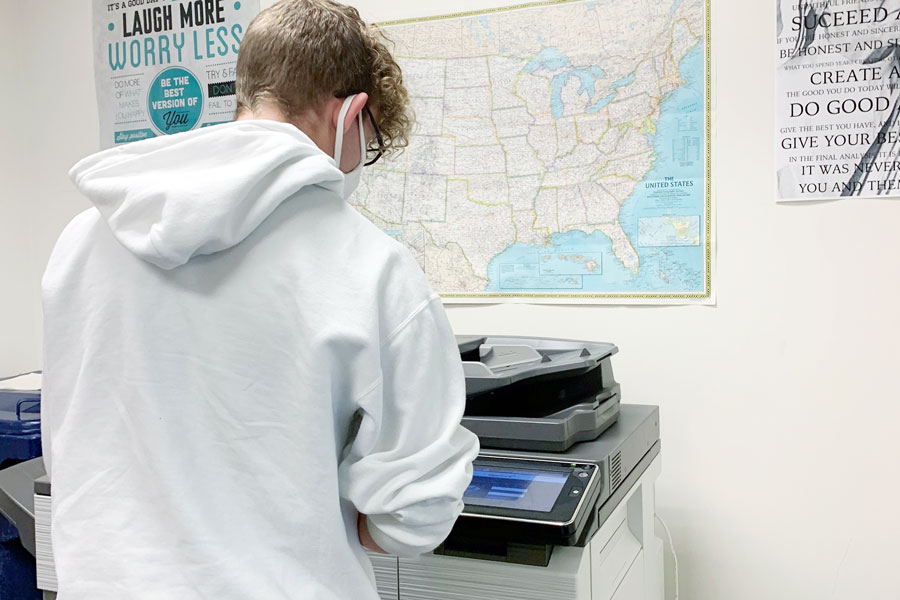 During passing period on Nov. 4, a student logs in to the copier in the library to complete a printing job. Issues with WiFi and printing have been solved over the course of the last few days. 