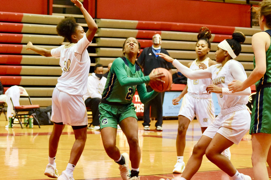 Senior Courtney Fields is surrounded by Warren Central players during the Sectional opener on Feb. 2 at North Central. 