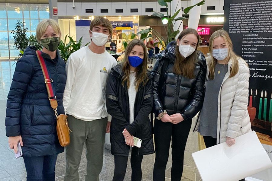 From left, host mother Mrs. Becky Van Rooy, host brother and junor Fisher Van Rooy host sister and freshman Anna Van Rooy, exchange student Julia Wesjohann and host sister and freshman Maggie Van Rooy gather in the Indianapolis International Airport to welcome their guest from Germany.