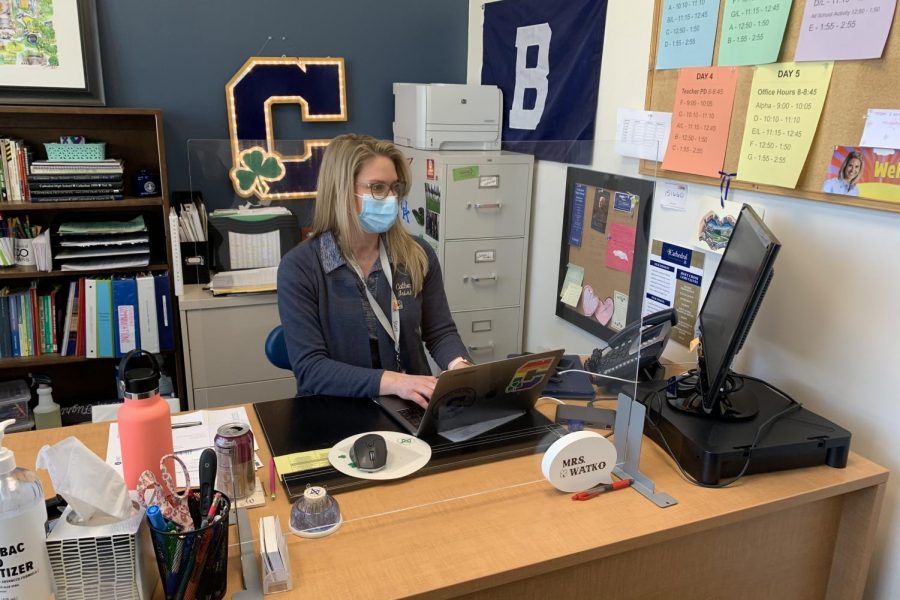 Mrs. Gretchen Watko '00 works in her office in Kelly Hall. 