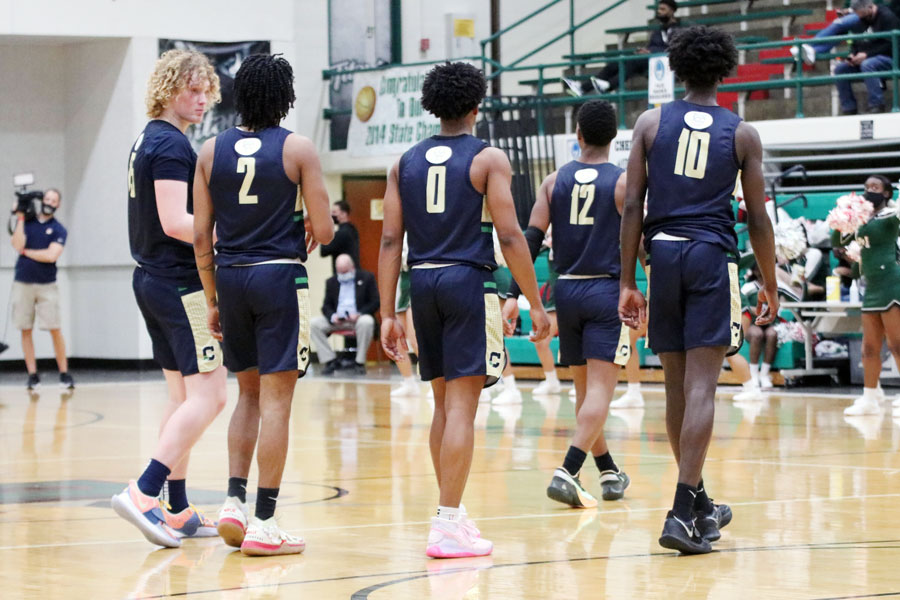 The varsity team heads onto the court during the Sectional game on March 3 against Lawrence North. 