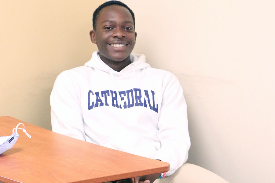 Sophomore Josh Omoruyi gets settled in to his seat before the start of his speech class with Mrs. Melinda Bundy. 