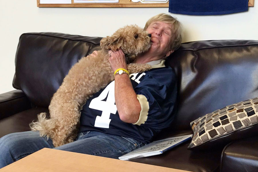 Last year before the pandemic, English teacher Mrs. Melina Bundy greets Muffin, the school’s former helper dog, in the counseling center. Or maybe it’s Muffin that is greeting Bundy, who will retire at the end of the semester.