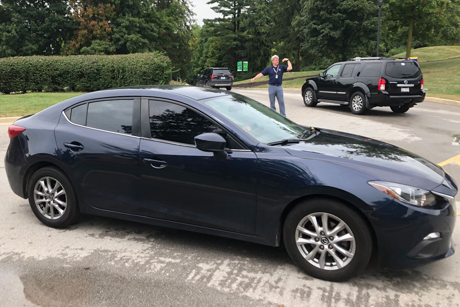 After school on Aug. 25, social studies teacher Mr. Eric Bruns directs traffic in the circle. Drivers who use a handheld device while on the road now could face fines as much as $500.