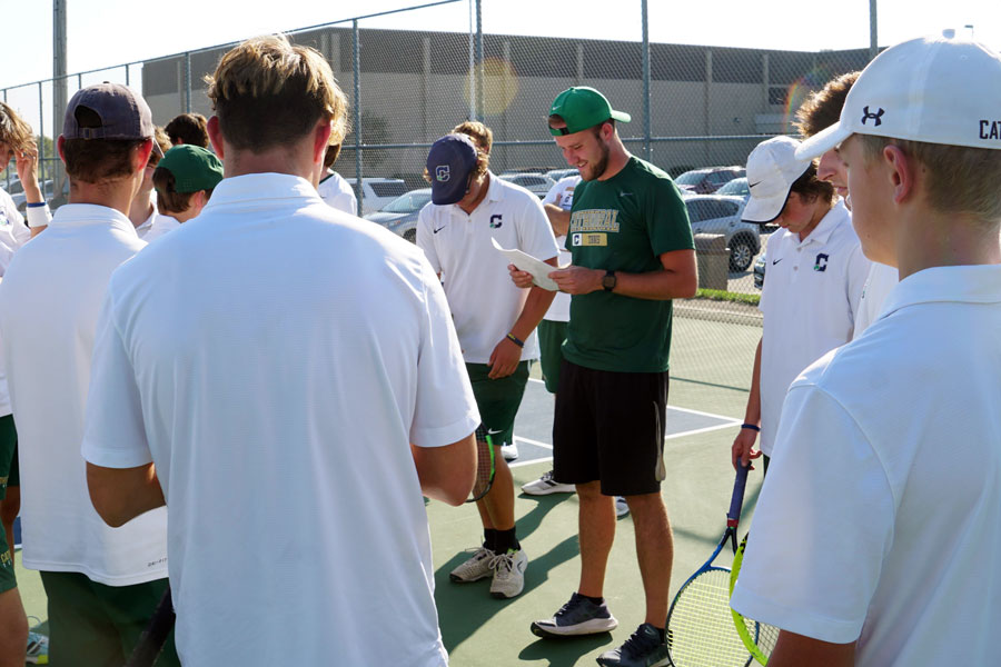 Assistant Coach Mr. Cole Hepp gives directions to the men's tennis team at the regular season match at Noblesville. 