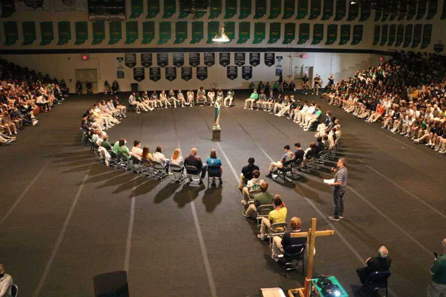 Director of campus ministry Mr. Dave Neeson  makes comments to the gathered student body during the praying of the rosary on Oct. 8. 