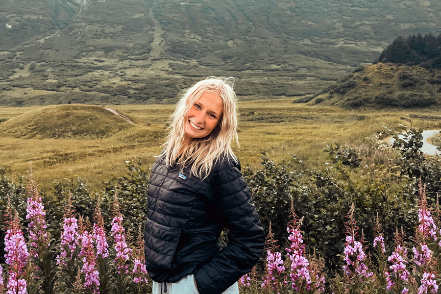 In Alaska's Turnagin Pass, senior Sloan Medders stands in a field of fireweed. 