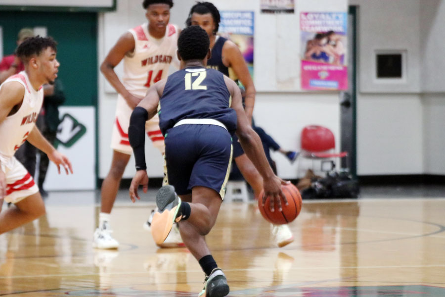 During last year's Sectional, senior Tayshawn Comer brings the ball up the court against Lawrence North. 