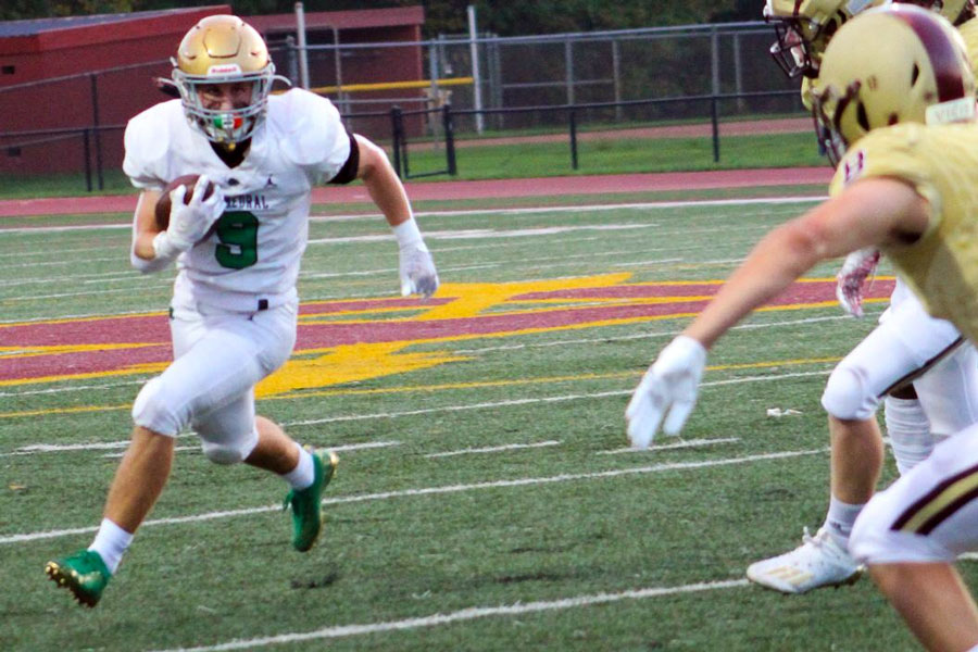 During the regular season game against Brebeuf Jesuit, senior running back Seth Mencer sweeps right. Mencer and his teammates will host New Palestine on Nov. 12 for the Regional championship. 