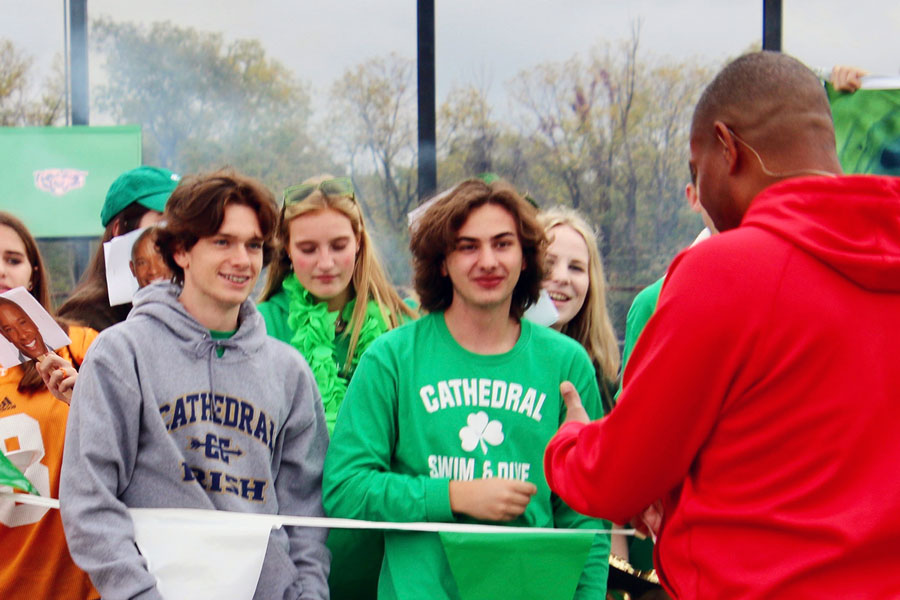 Cole Brewer and Max Timberman greet WISH-TV's Mr. Anthony Calhoun at the Center Grove football game earlier this school year. 