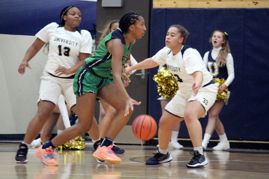 During the regular season game against University, junior Layla Gold advances the ball up the court. 