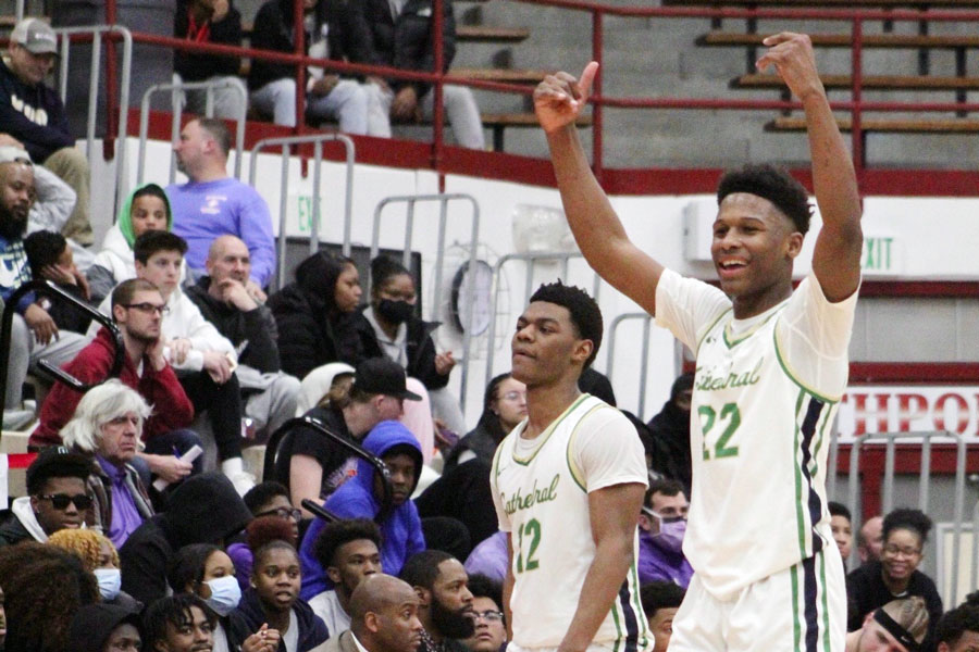 At the conclusion of the team's 72-57 win over Ben Davis, Tayshawn Comer and Jaron Tibbs celebrate the Regional championship. 