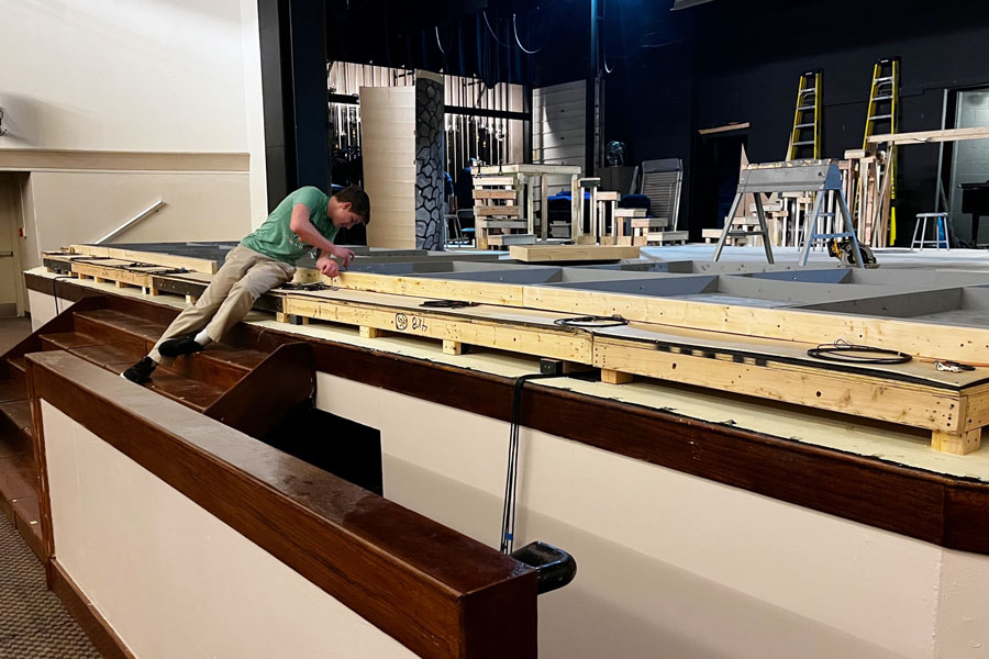 Sophomore Paul Sheddy works on the set during his E period tech theater class.