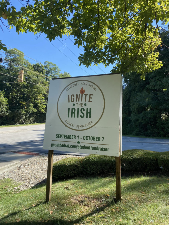 At the bottom of the hill a sign can be seen letting passersby know of the fundraiser to come.