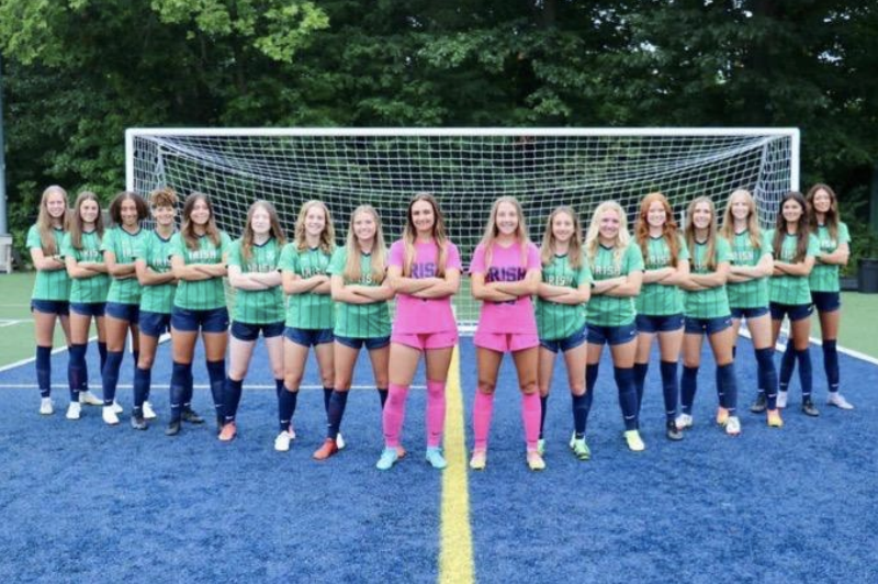 Lady Irish varsity players pose for a picture before practicing.