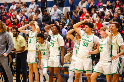 The team celebrates a teammates dunk during the game.