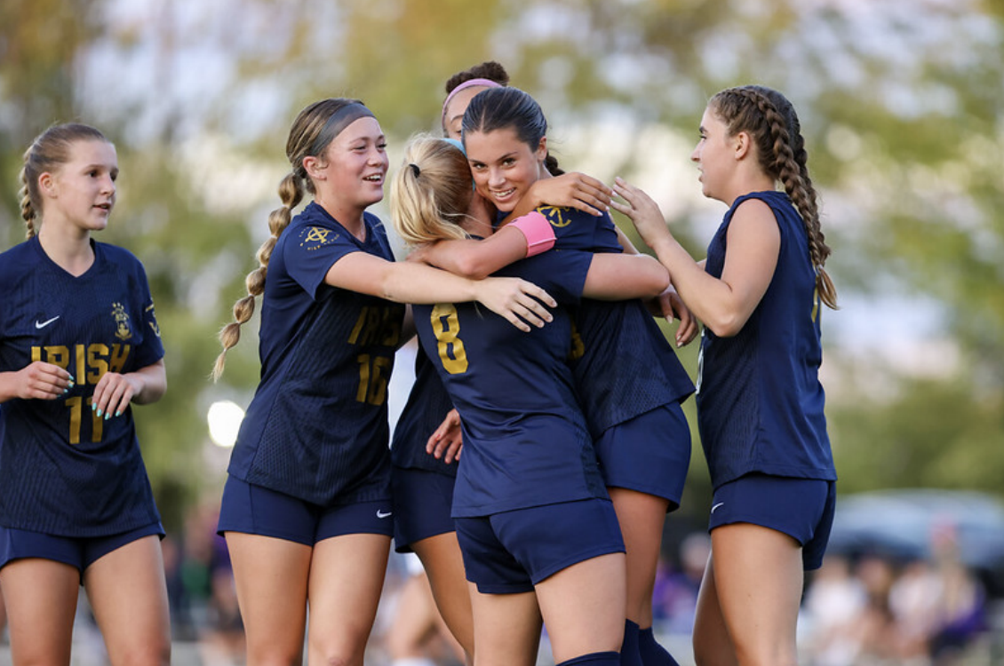 The team celebrates a goal by Senior Eliza Langfeldt during a game against Guerin Catholic on Sat. 18. The team won the game 3-0.