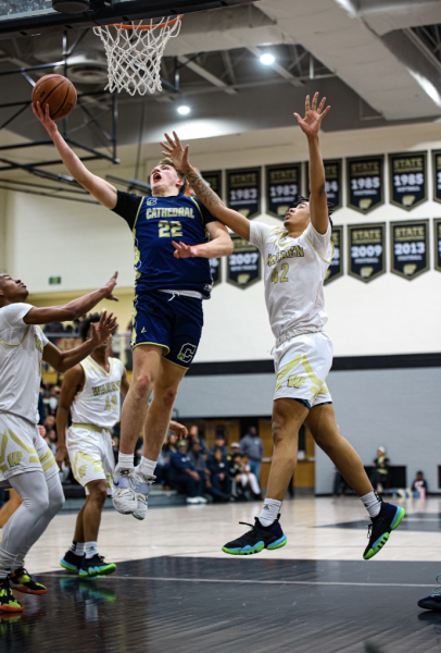 Aidan Hughes makes a layup last year while on the road against the Warren Central Warriors. Last year Varsity defeated Warren 76-71 in double overtime.