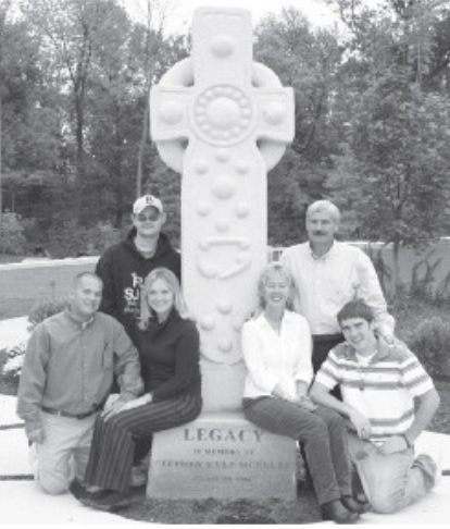 “The McNulty family at the dedication of the cross in October 2006. Front row, from left: Jason McClellan '98, Kristin McNulty-McClellan '98, Jacque McNulty '78 and Patrick McNulty '08. Back row, from left: Brad McNulty '01 and Jerry McNulty '76. 17 years later, the cross still shows Stephen’s legacy and love. 
(https://mycathedrallegacy.com/meet-our-donors/creating-a-true-legacy-at-cathedral)