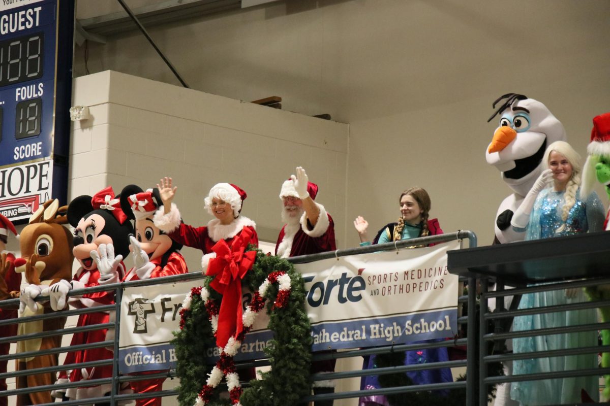 Santa, Mrs. Claus, and other Disney characters wave to all the students below. Santa spent the entire afternoon talking to the Enlace kiddos in front of the Mary wall in the Innovation Center. Mrs. Claus read stories in the library when she wasn't sitting with Santa, and the Disney characters walked around bringing joy to every kid.