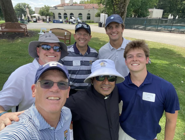 President Dr. Rob Bridges (bottom left)  takes a selfie with Father Jomy Matthews, Dr. Neeson, and 3 participants. Exciting reunions between the individuals pictured were shared during the Father Kelly Golf Outing. “It is important for our community to support this cause just as it is for all of our events, it supports our economic model so we can keep on doing God’s work here on the Hill,” said Bridges. 
