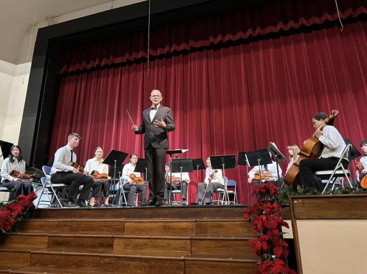 Orchestra Director Steve Goodman leads Cathedral High school orchestra during the Christmas concert on Monday evening. The ensemble performed challenging pieces including Midnight Rain, Evening Sun, and Allegro. The performance reflected the group's focus, growth, and dedication developed throughout the semester.