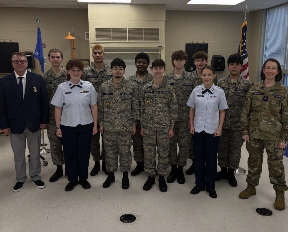 Civil Air Patrol Cadets and Robert Kouril smile for the camera, joined by Indiana Wing Colonel Jamie Griffith. Nine Cathedral Cadets are promoted to higher ranks by Indiana Wing Colonel Jamie Griffith. Garza said, “When Colonel Griffith pinned my insignia, she said something that stuck with me: ‘the first one is always the heaviest’. This made me think how much farther I could go in CAP.” 